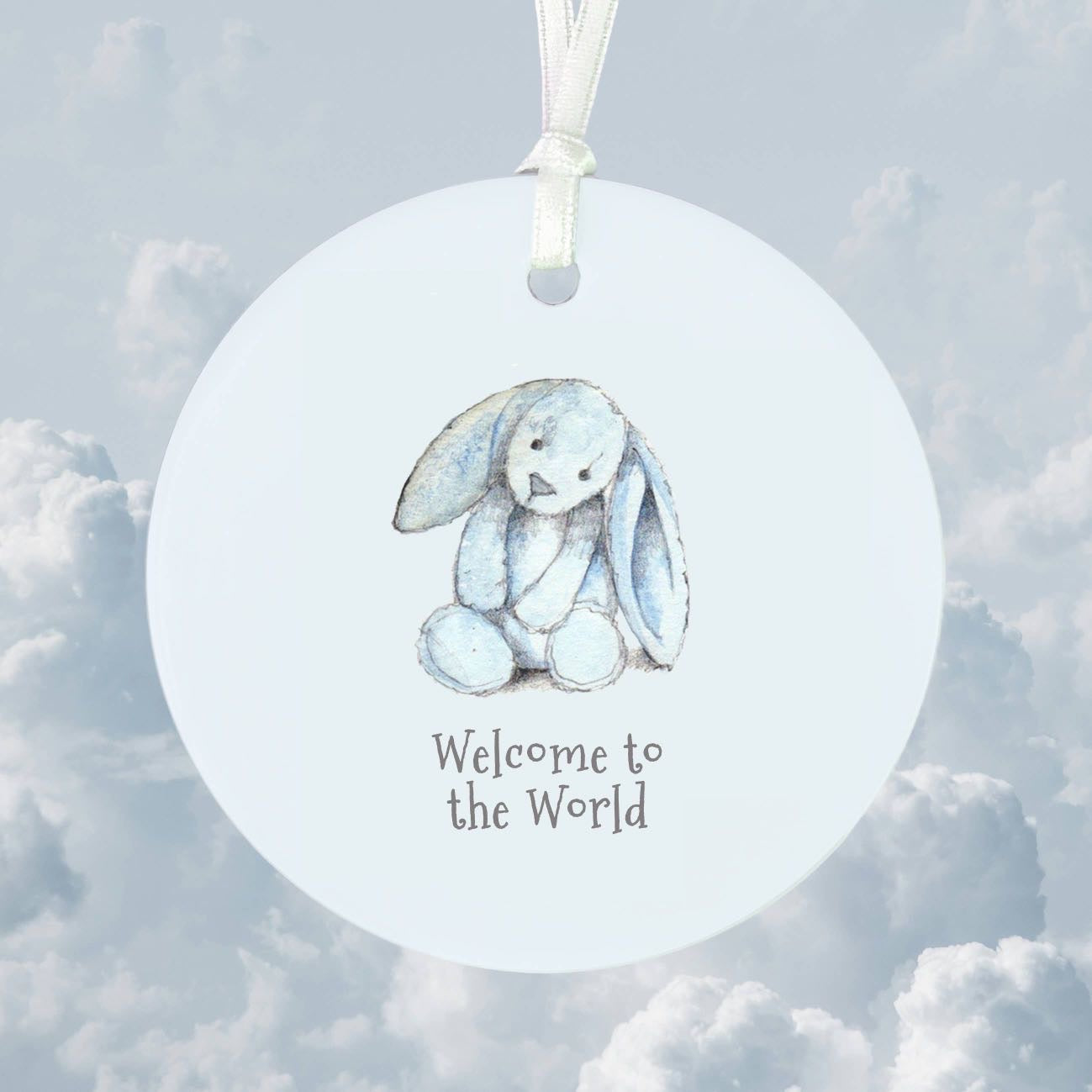 “Welcome to the World hanging decoration with blue bunny illustration and ribbon”