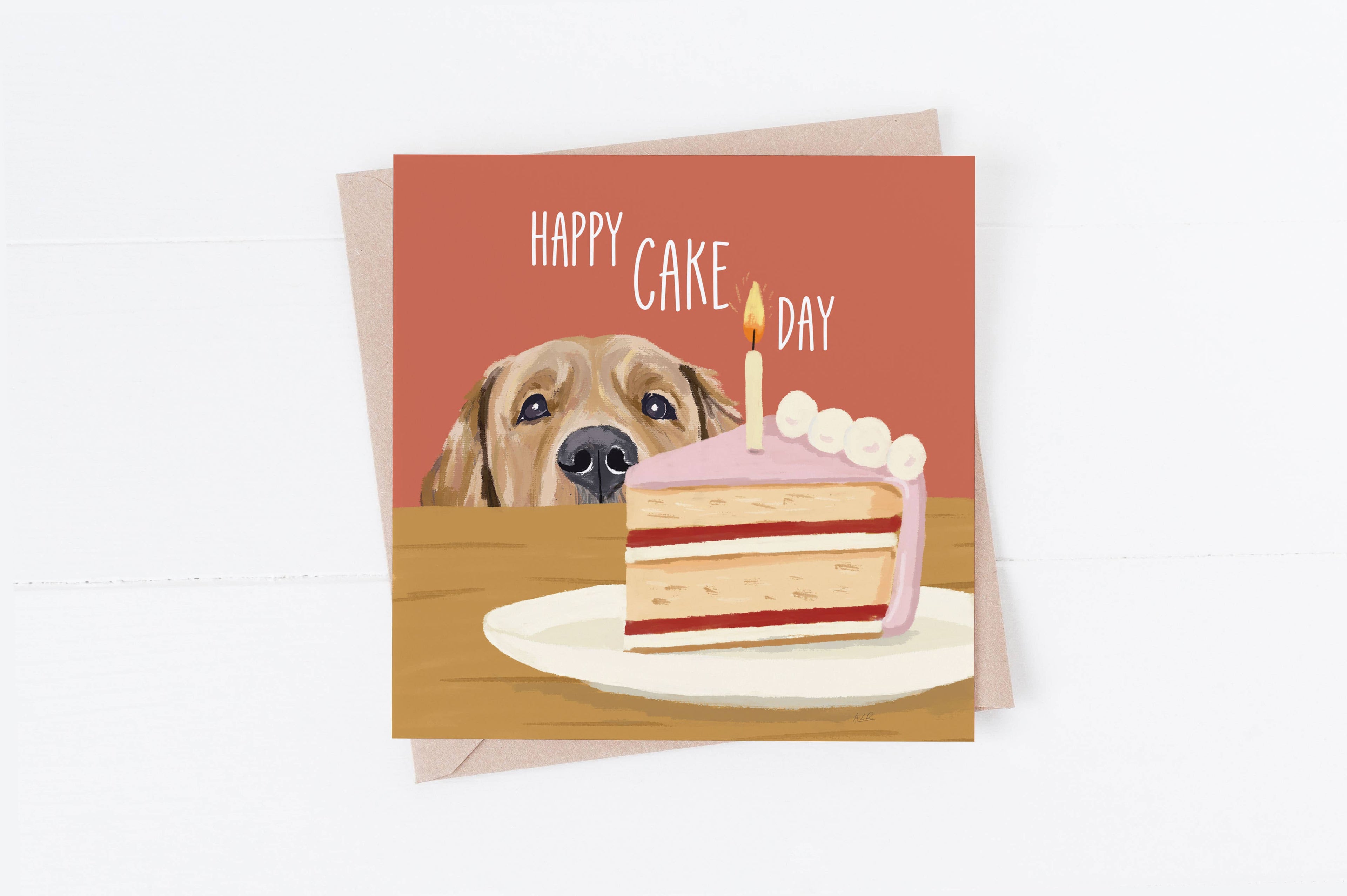 Happy Cake Day birthday card with dog peeking at slice of cake with candle, blank inside, kraft envelope