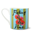 HiJiNX Feeling Vine ceramic mug in bold blue and olive-gold vertical stripes with a vine tomato illustration, presented alongside its bright pink matching gift box.