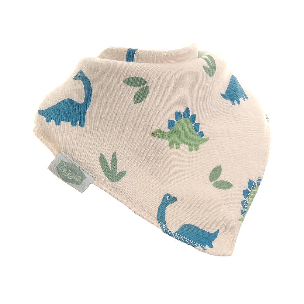 Ziggle baby bandana bib in soft jersey fabric with an all-over repeat pattern of blue brachiosaurus and green stegosaurus dinosaurs on a cream background, laid flat.