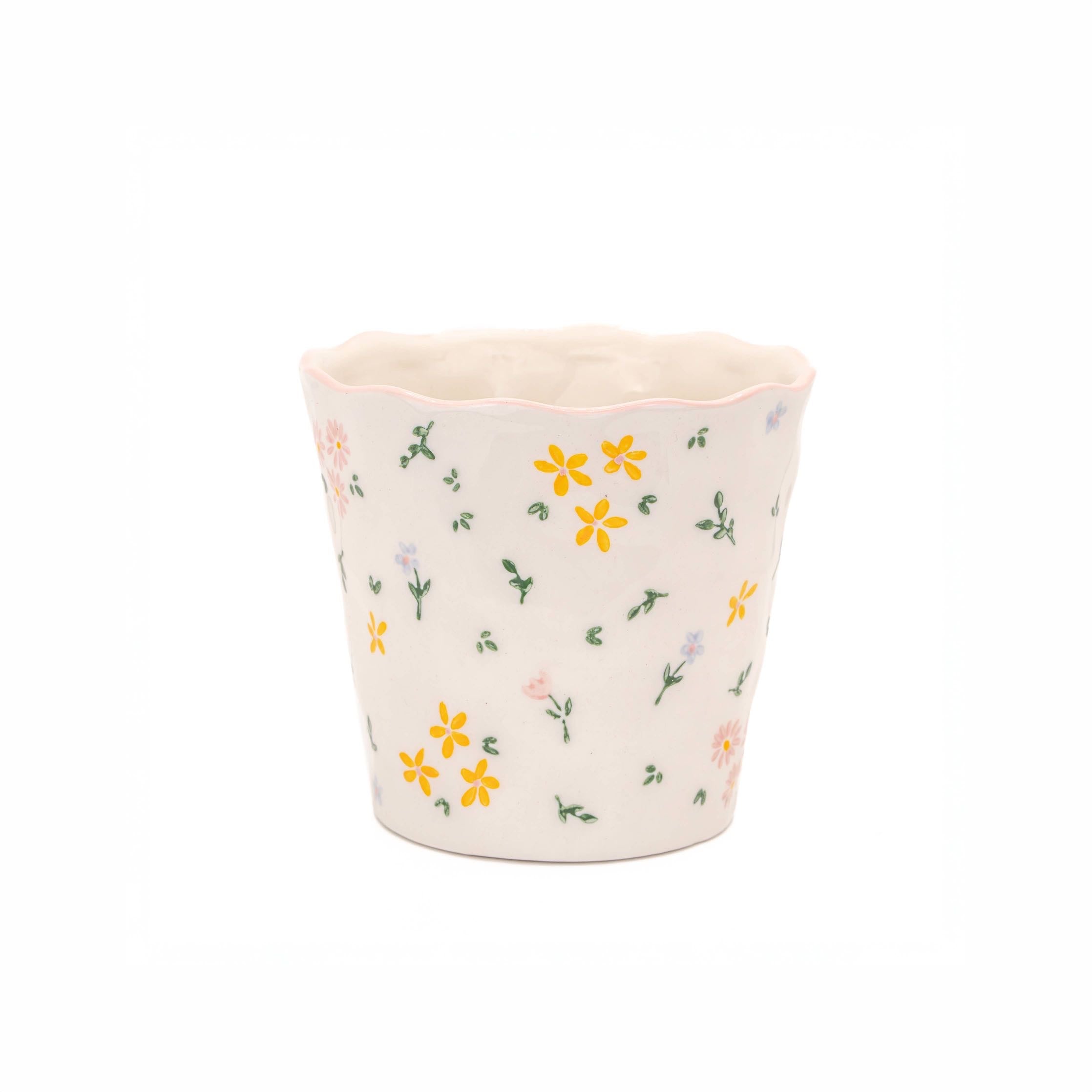 Small white floral ceramic plant pot with scalloped rim and hand-painted style flowers