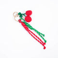 Clip-on cherry bag charm with red cherries, green leaf and red/green cord tassels