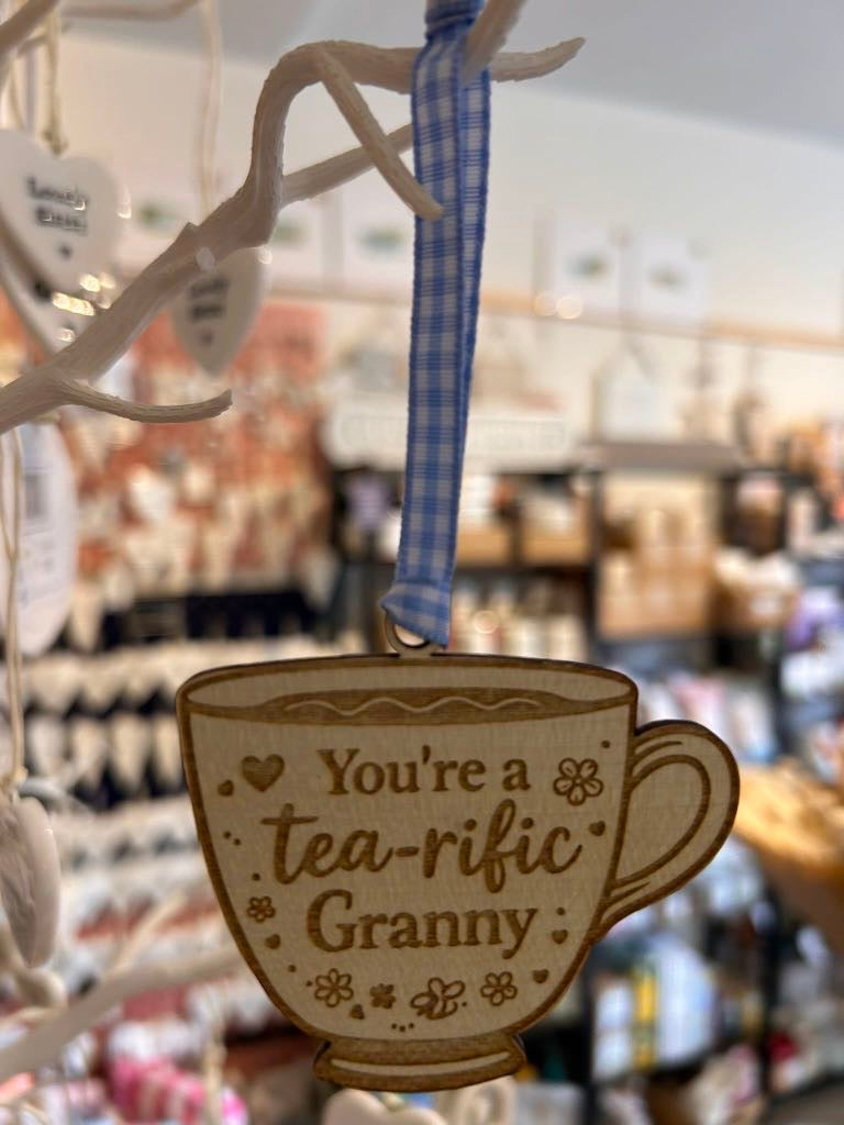 Wooden teacup hanging decoration with ribbon engraved “You’re a tea-rific Granny”